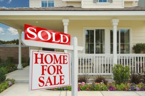 Sold Home For Sale Sign in front of Beautiful New Home.