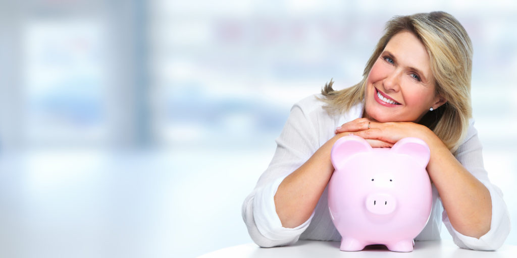 Smiling senior woman with piggy bank. Saving account.
