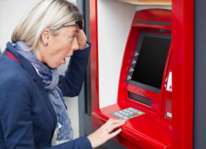 Shocked woman looking at her bank account balance