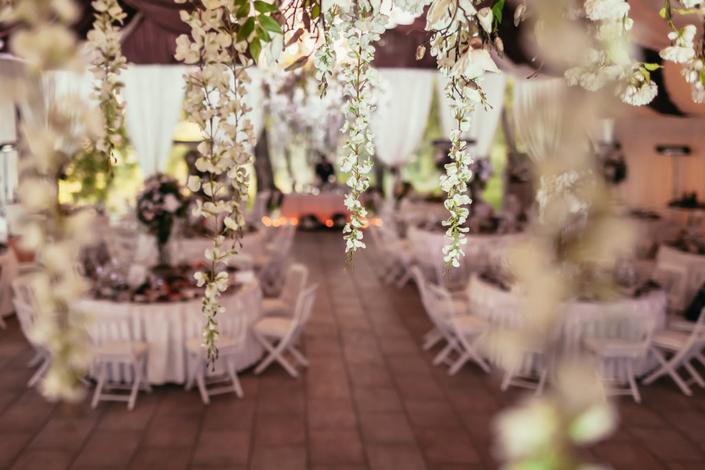 flowers decoration on wedding banquet with tables and catering