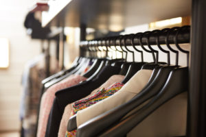 Clothes on hangers in shop. Close up. Shallow dof